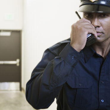 Security guard using a walkie-talkie